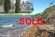 Little White House on 3.45 acres and 65 m shorefront at Bras d’Or Lake with panoramic lake view for sale in Little Narrows near Iona and Baddeck on Cape Breton Island, Nova Scotia, Canada