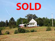 72 acr property with fixer-upper farmhouse and 330 m waterfront at River Denys for sale on Cape Breton Island, Nova Scotia, Canada